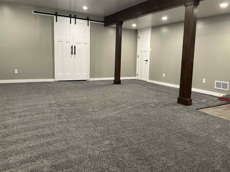 Finished basement with new dark grey carpet installed
