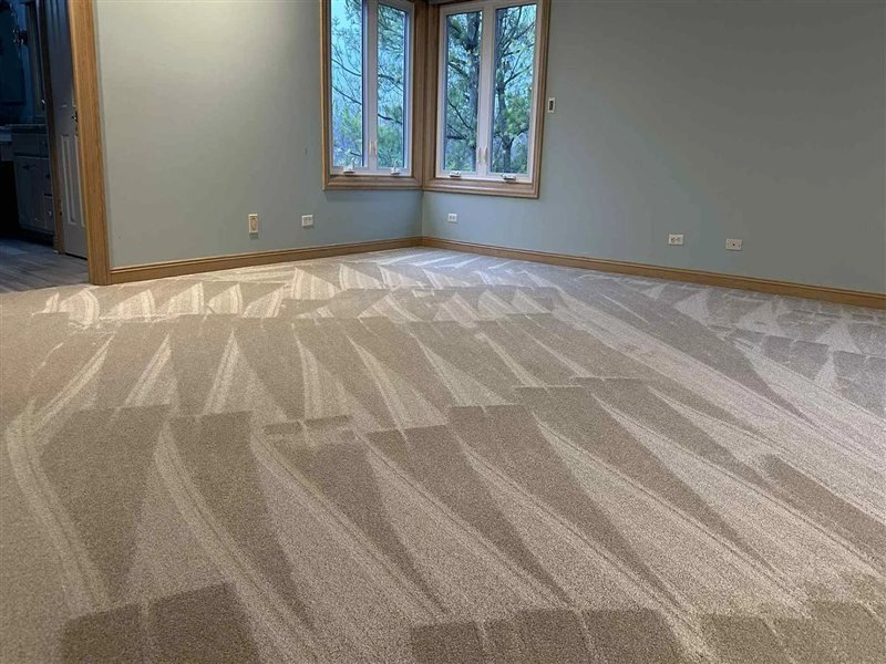 Freshly stretched and installed plush carpet in a bedroom