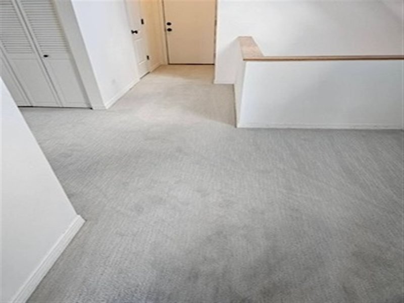 Hallway carpet installation with light grey carpet