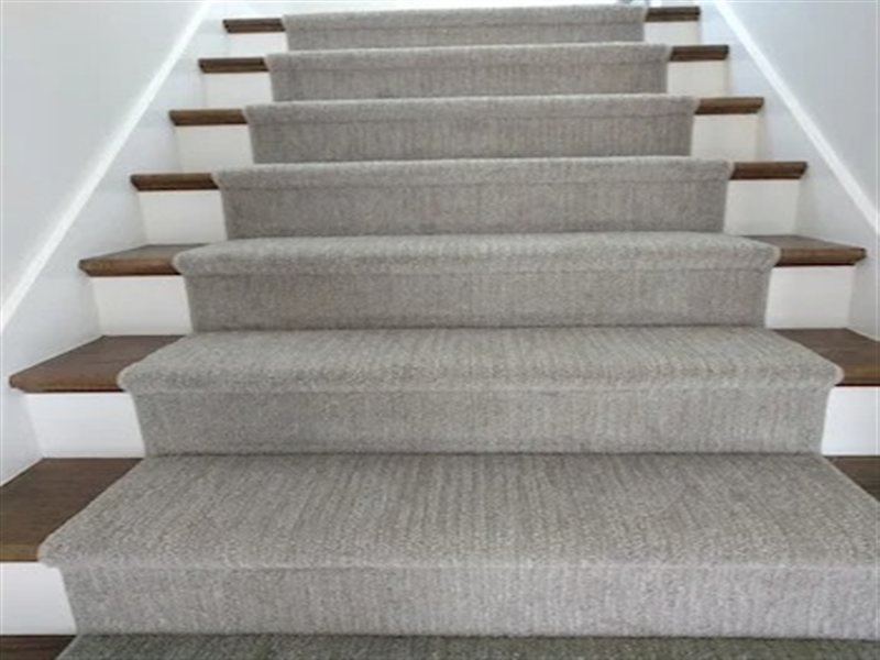 Stair carpet runner installation with grey textured carpet and wood nosing